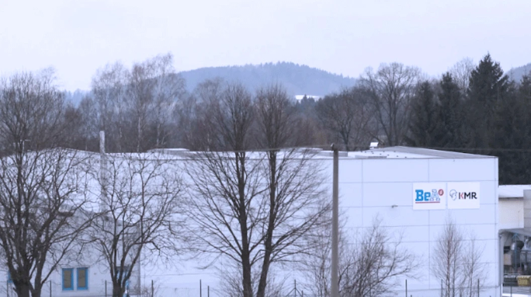 WORKPRO industrial building in the Czech Republic with white walls, leafless trees and wooded hills behind WORKPRO industrial building in the Czech Republic with white walls, leafless trees and wooded hills behind