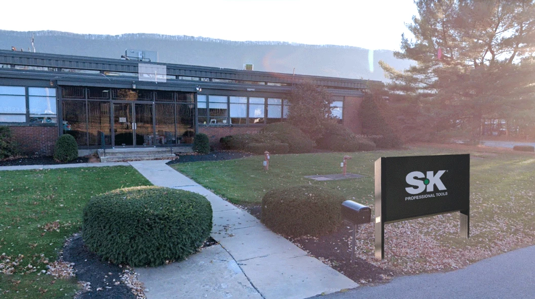 WORKPRO SK facility in the United States with a glass-fronted entrance, a paved walkway and a freestanding sign WORKPRO SK facility in the United States with a glass-fronted entrance, a paved walkway and a freestanding sign