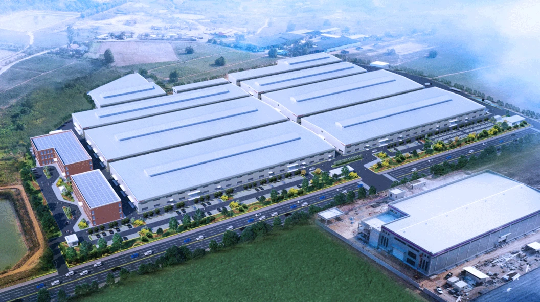 WORKPRO industrial complex in Thailand with long white factory roofs and surrounding roads, seen from above WORKPRO industrial complex in Thailand with long white factory roofs and surrounding roads, seen from above