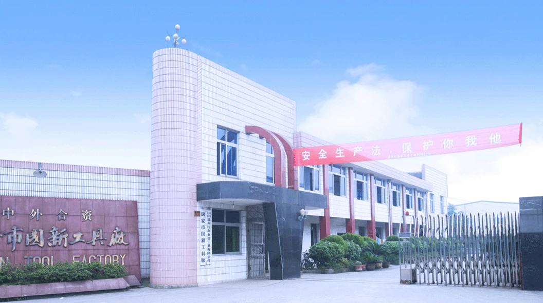 WORKPRO GreatStar factory entrance in China with a tiled facade, a red safety banner and a retractable metal gate WORKPRO GreatStar factory entrance in China with a tiled facade, a red safety banner and a retractable metal gate